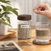 A heart-shaped tablet storage box with a transparent glass jar and a wooden lid details Picture